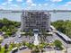 An aerial view shows the building, parking and waterfront location on a sunny day at 500 N Osceola Ave # 811, Clearwater, FL 33755