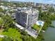 Scenic aerial view of a high-rise condo building with lush landscaping, overlooking the bay at 500 N Osceola Ave # 811, Clearwater, FL 33755