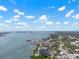 Breathtaking aerial view of the coast, highlighting waterfront homes and tranquil bay waters under a picturesque sky at 500 N Osceola Ave # 811, Clearwater, FL 33755