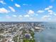 Expansive aerial view of a coastal city showcasing its waterfront location and architectural diversity under a bright, cloudy sky at 500 N Osceola Ave # 811, Clearwater, FL 33755