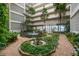The charming courtyard features lush landscaping, a fountain, and serene seating areas at 500 N Osceola Ave # 811, Clearwater, FL 33755
