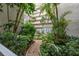 A beautiful gravel path winding through the lush greenery of the residential building's courtyard at 500 N Osceola Ave # 811, Clearwater, FL 33755