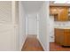 Hallway featuring wood floors leading to the kitchen with tile flooring at 500 N Osceola Ave # 811, Clearwater, FL 33755