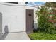 Private outdoor shower with wood door and lush tropical landscaping offers a refreshing experience at 500 N Osceola Ave # 811, Clearwater, FL 33755