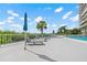 Spacious pool deck features lounge chairs and umbrellas, perfect for sunbathing and enjoying the ocean breeze at 500 N Osceola Ave # 811, Clearwater, FL 33755
