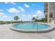 Enjoy the stunning water view by the pool with blue skies and palm trees, perfect for relaxation at 500 N Osceola Ave # 811, Clearwater, FL 33755
