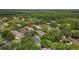 Scenic aerial view of a condo building with mature trees, parking, and a community pool at 5100 Burchette Rd # 2702, Tampa, FL 33647