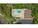 Directly overhead shot of a condo community pool, featuring a hot tub, loungers, and cabana at 5100 Burchette Rd # 2702, Tampa, FL 33647