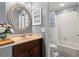 Cozy bathroom featuring a vanity, a decorative mirror, and tiled shower with a floral curtain at 5100 Burchette Rd # 2702, Tampa, FL 33647