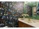 Stylish half bath with a unique floral wallpaper and modern vanity at 5100 Burchette Rd # 2702, Tampa, FL 33647