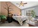 Cozy bedroom featuring a queen bed, accent wall with floral mural, and a bright window seat at 5100 Burchette Rd # 2702, Tampa, FL 33647
