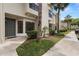 Townhouse entrance with lush landscaping, including a tree, shrubs, and plants enhancing curb appeal at 5100 Burchette Rd # 2702, Tampa, FL 33647