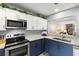 This is a spacious kitchen with stainless steel appliances, granite countertops, and modern two-tone cabinets at 5100 Burchette Rd # 2702, Tampa, FL 33647