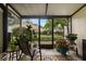 Enclosed lanai featuring outdoor seating and a view of the community landscaping at 5100 Burchette Rd # 2702, Tampa, FL 33647