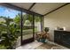 Cozy enclosed lanai with outdoor seating, colorful plants, and community views at 5100 Burchette Rd # 2702, Tampa, FL 33647