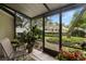 Relaxing enclosed lanai with seating and peaceful views of the community landscaping at 5100 Burchette Rd # 2702, Tampa, FL 33647