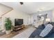 Cozy living room complete with TV, staircase, and open flow into kitchen and dining area at 5100 Burchette Rd # 2702, Tampa, FL 33647