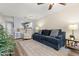 Comfortable living room featuring a modern sofa, fan, and updated flooring throughout the space at 5100 Burchette Rd # 2702, Tampa, FL 33647
