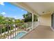 Balcony offering an overhead view of the fenced pool area and lush landscaping at 512 1St St # 108, Indian Rocks Beach, FL 33785