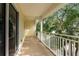 Spacious balcony with a white railing and views of tropical foliage at 512 1St St # 108, Indian Rocks Beach, FL 33785