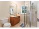 Well-lit bathroom featuring a glass-enclosed shower and a vanity with a sink at 512 1St St # 108, Indian Rocks Beach, FL 33785