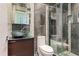 Modern bathroom featuring a glass shower, mosaic tile accents, and a unique sink design at 512 1St St # 108, Indian Rocks Beach, FL 33785