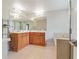 Bathroom with double vanity, tiled floor, large mirrors, and a separate soaking tub at 512 1St St # 108, Indian Rocks Beach, FL 33785
