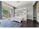 Bright bedroom features a bunk bed, dark wood floors, and a closet at 512 1St St # 108, Indian Rocks Beach, FL 33785