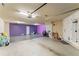 Spacious garage with ample storage space, purple accent wall, and garage door opener at 512 1St St # 108, Indian Rocks Beach, FL 33785