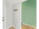 Hallway with painted walls, tile floor, coat hooks, and neutral trim at 512 1St St # 108, Indian Rocks Beach, FL 33785