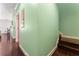 Hallway with wood floors and light-green walls, leading to a bathroom and other rooms at 512 1St St # 108, Indian Rocks Beach, FL 33785