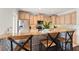 Kitchen with wooden cabinetry, stainless steel appliances, granite countertops and breakfast bar seating at 512 1St St # 108, Indian Rocks Beach, FL 33785