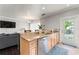 Open kitchen with stainless steel dishwasher, granite countertops, and access to outdoor deck at 512 1St St # 108, Indian Rocks Beach, FL 33785