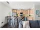 Eat-in kitchen featuring counter seating, stainless steel appliances, and wooden cabinetry at 512 1St St # 108, Indian Rocks Beach, FL 33785