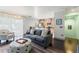 Cozy living room with dark wood floors, comfortable seating, and access to the kitchen at 512 1St St # 108, Indian Rocks Beach, FL 33785