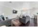 Cozy living room with sofas, a flat-screen TV, and access to a bright, screened-in balcony at 512 1St St # 108, Indian Rocks Beach, FL 33785