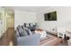 Comfortable living room with a flat-screen TV, striped pillows, and a decorative ottoman at 512 1St St # 108, Indian Rocks Beach, FL 33785