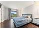 Comfortable main bedroom with hardwood floors, balcony access and modern furnishings at 512 1St St # 108, Indian Rocks Beach, FL 33785