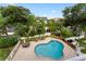 Aerial view of the fenced community pool area with outdoor seating and landscaping at 512 1St St # 108, Indian Rocks Beach, FL 33785