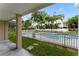Covered patio view of the fenced community pool with lush tropical landscaping at 512 1St St # 108, Indian Rocks Beach, FL 33785