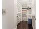 Organized walk-in closet with white shelving, drawers, and ample storage space at 512 1St St # 108, Indian Rocks Beach, FL 33785
