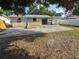 Spacious backyard featuring a concrete patio, partially fenced with mature tree coverage at 5175 88Th N Ave, Pinellas Park, FL 33782