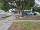 Charming single-story home featuring a large tree, tidy landscaping, and a cozy, inviting curb appeal at 5175 88Th N Ave, Pinellas Park, FL 33782