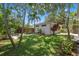 Lush backyard with a well-manicured lawn and guest house featuring a garden at 526 36Th Ne Ave, St Petersburg, FL 33704