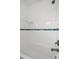 Bright bathroom featuring white tile walls with a decorative blue accent stripe and bathtub at 526 36Th Ne Ave, St Petersburg, FL 33704