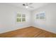 Bedroom featuring hardwood floors, plantation shutters, and a ceiling fan at 526 36Th Ne Ave, St Petersburg, FL 33704