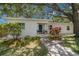 A charming single-story home with mature landscaping and a blue front door at 526 36Th Ne Ave, St Petersburg, FL 33704