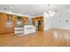 Open kitchen with custom cabinets, island with breakfast bar, stainless appliances, and hardwood floors at 526 36Th Ne Ave, St Petersburg, FL 33704