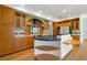 Spacious kitchen with custom cabinetry, a central island, and unique decorative backsplash at 526 36Th Ne Ave, St Petersburg, FL 33704