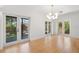 Open living space featuring large glass doors, hardwood floors, and modern lighting fixtures at 526 36Th Ne Ave, St Petersburg, FL 33704